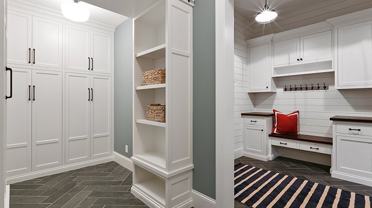 White cabinets and cubbies in the basement 