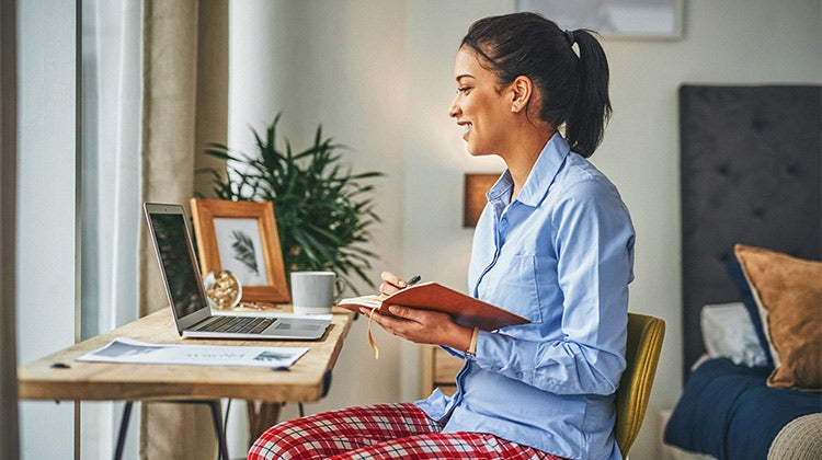 Woman working from home wearing pajama pants
