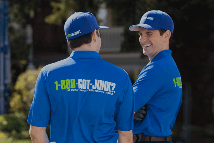 Two 1-800-GOT-JUNK? team members preparing for junk removal