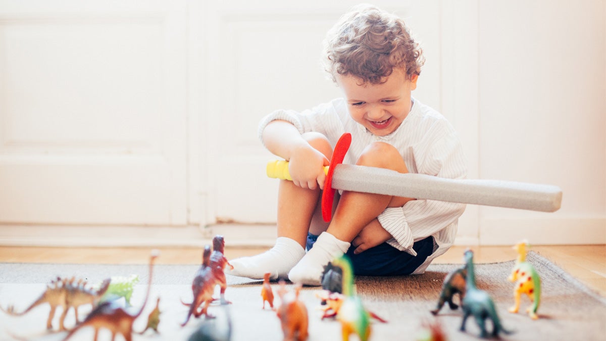 Toddler at home playing with toys