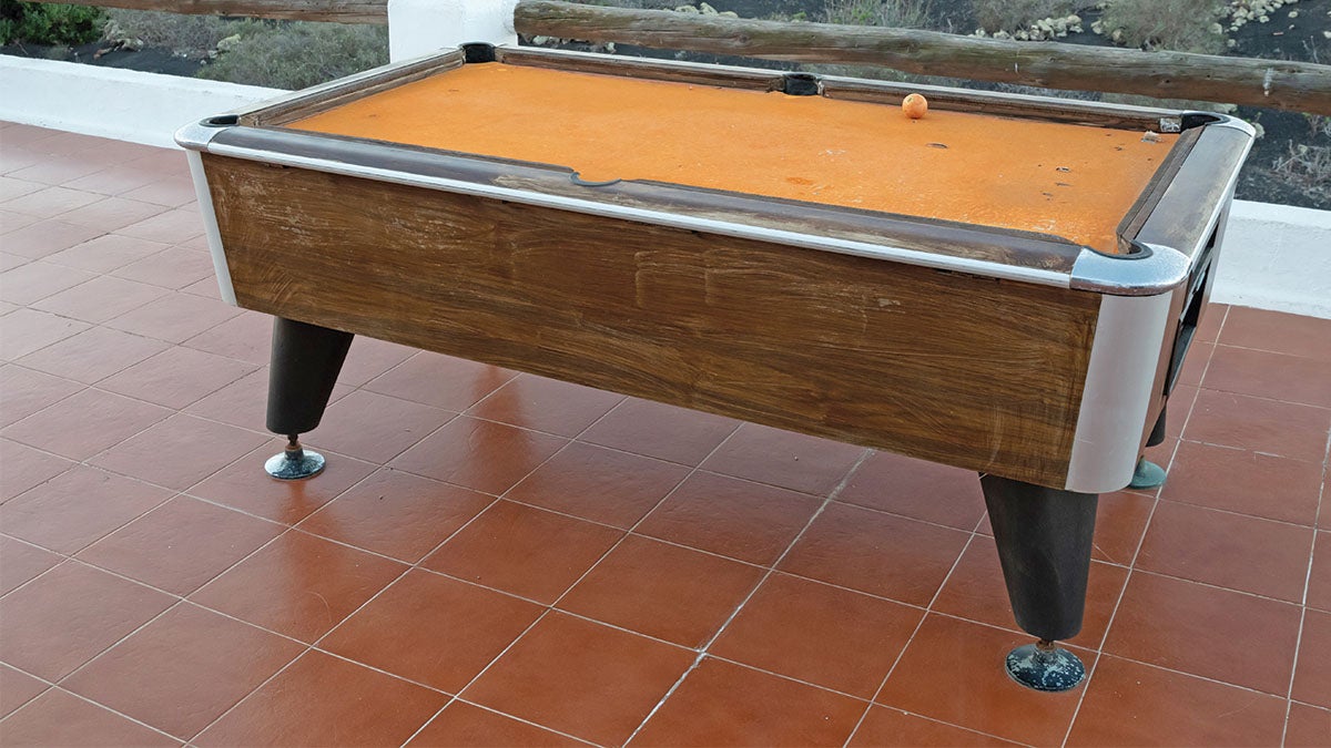 An old pool table ready for disassembly An old pool table ready for disassembly