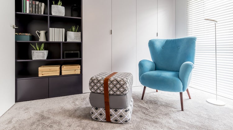 Sky blue chair and cushions in a white room