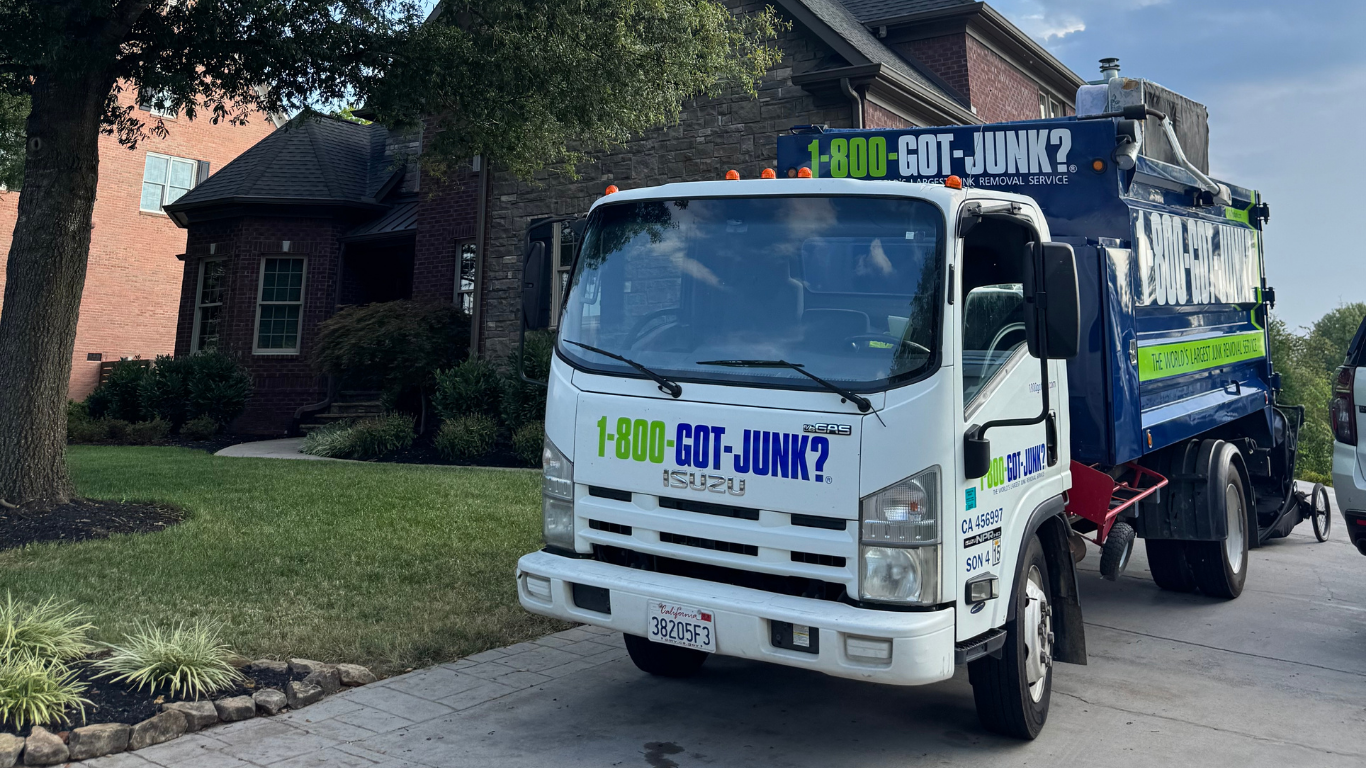 1-800-GOT-JUNK? truck in front of a house. 1-800-GOT-JUNK? truck in front of a house.
