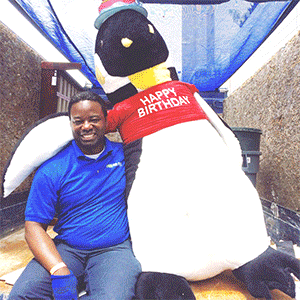 TOM posing with giant penguin plush in a truck TOM posing with giant penguin plush in a truck