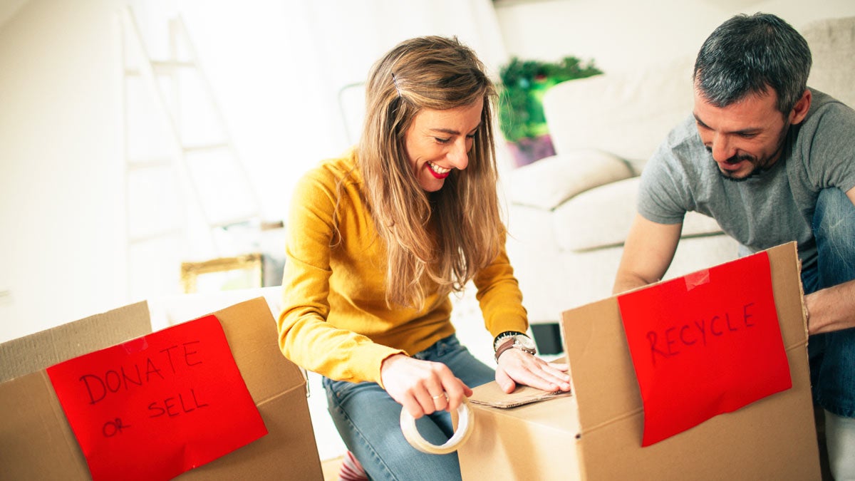 Couple organizing living room with boxes