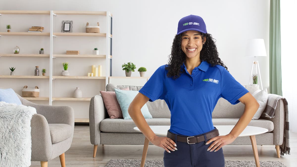 A 1-800-GOT-JUNK? Truck Team Member standing in a clean decluttered space.