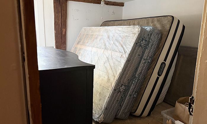 A stack of donated mattresses in good condition.