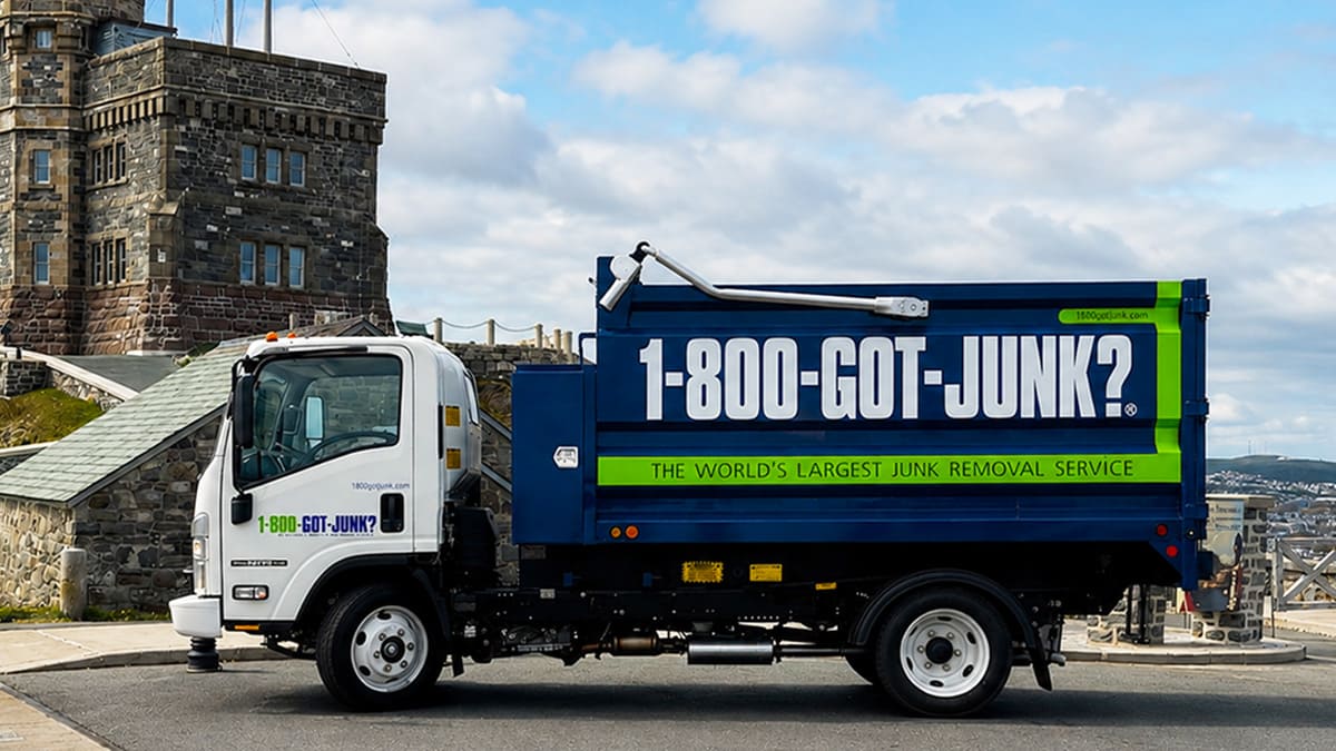 The 1-800-GOT-JUNK? truck in front of Cabot Tower, located at the summit of Signal Hill National Historic Site in St. John’s.