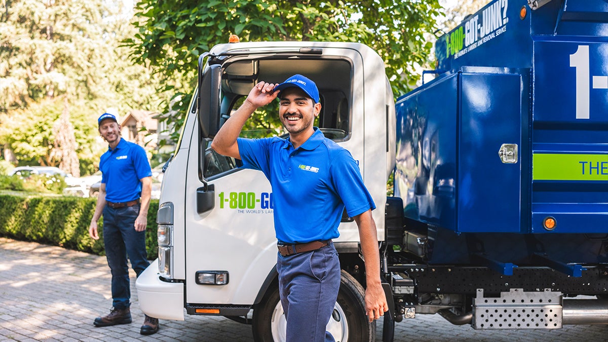 Two 1-800-GOT-JUNK? Truck Team Members helping a customer.