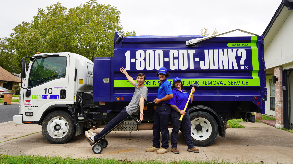 Dawson DIY with 1-800-GOT-JUNK? team members standing in front of a junk removal truck smiling