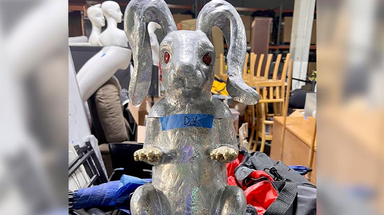 Silver bunny statue with red eyes