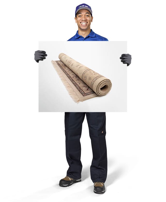 1-800-GOT-JUNK? Truck Team Member holding an image of an area rug