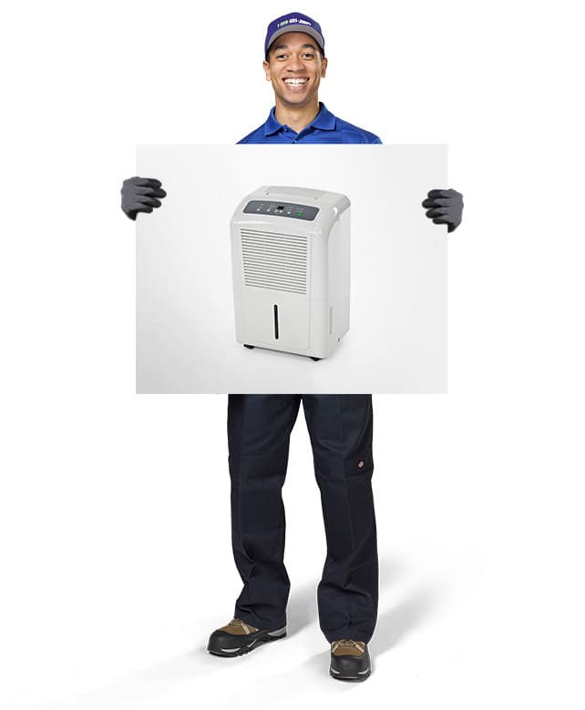 1-800-GOT-JUNK? Truck Team Member holding an image of a dehumidifier