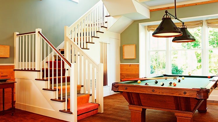 Image of a pool table next to the stairway