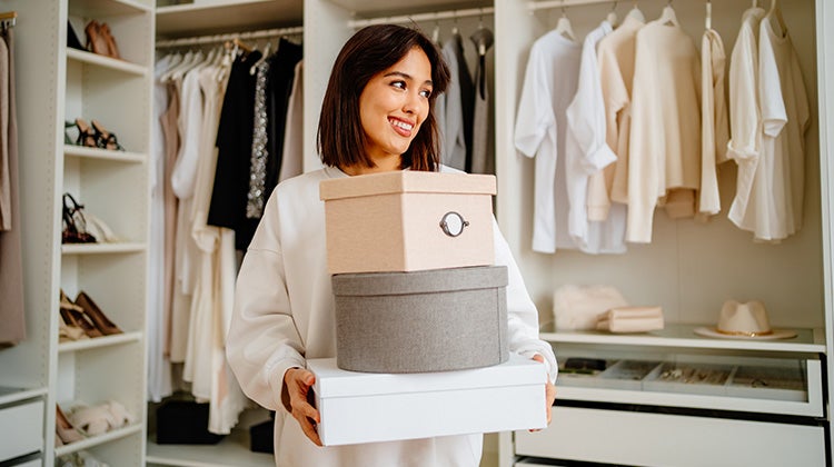 Spring cleaning importance Woman organizing holding storage boxes