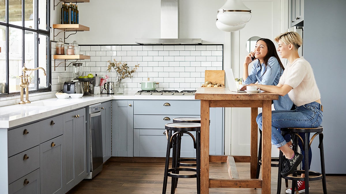 Two people sitting in bright clean kitchen