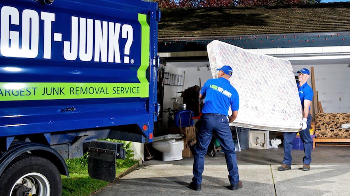 1-800-GOT-JUNK? Truck Team taking a mattress for recycling