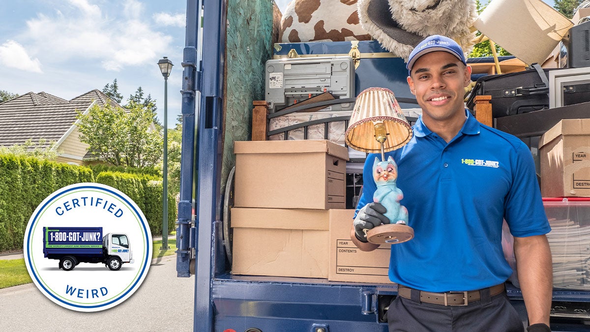 1-800-GOT-JUNK? Truck Team Member holding a weird lamp