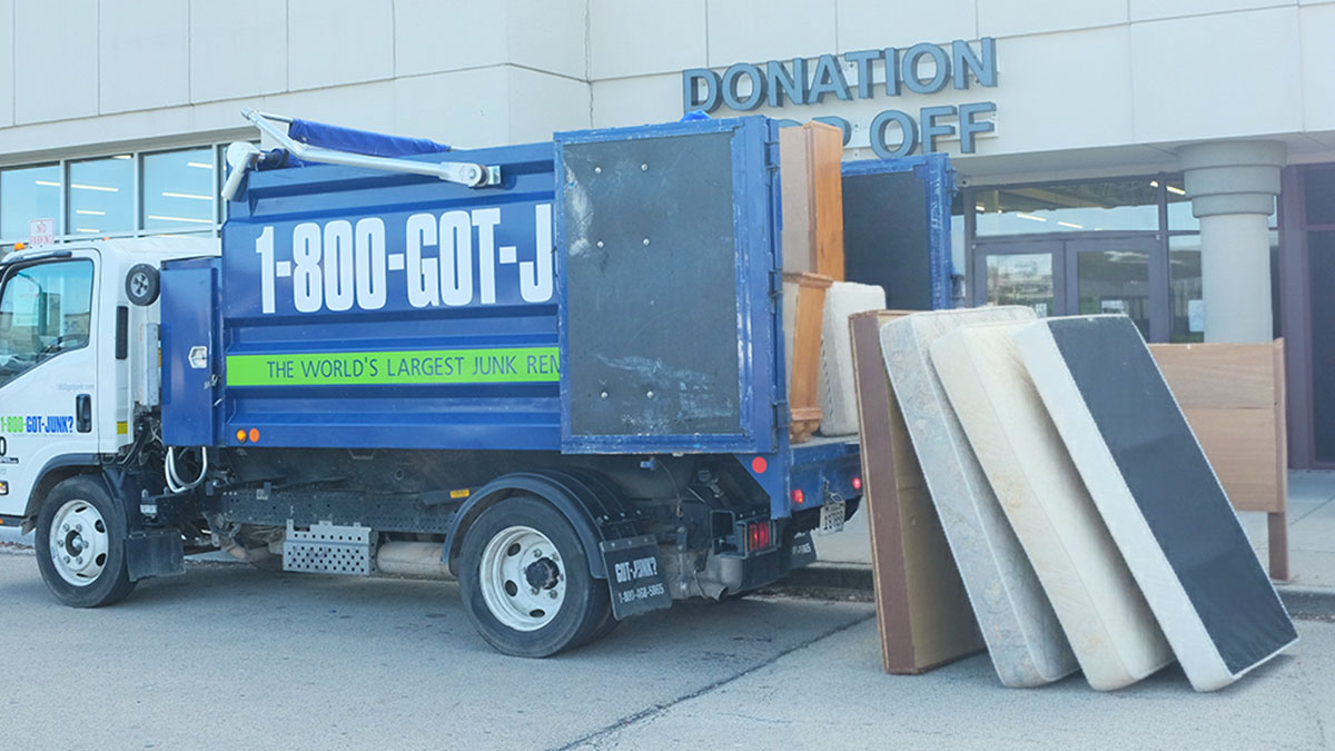 1-800-GOT-JUNK? dropping off used mattresses at a charitable organization.