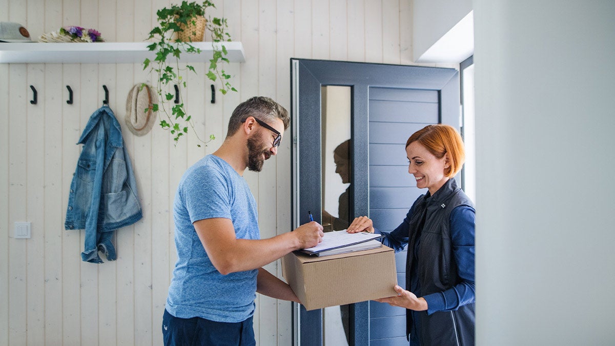 Man signing for a post office delivery 