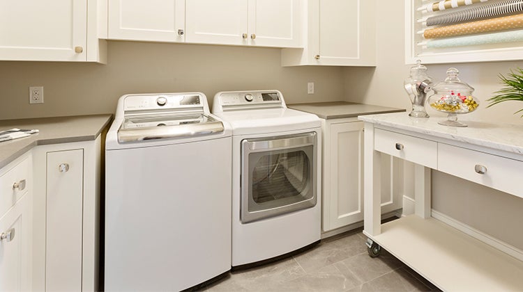 Basement laundry room with cabinets 