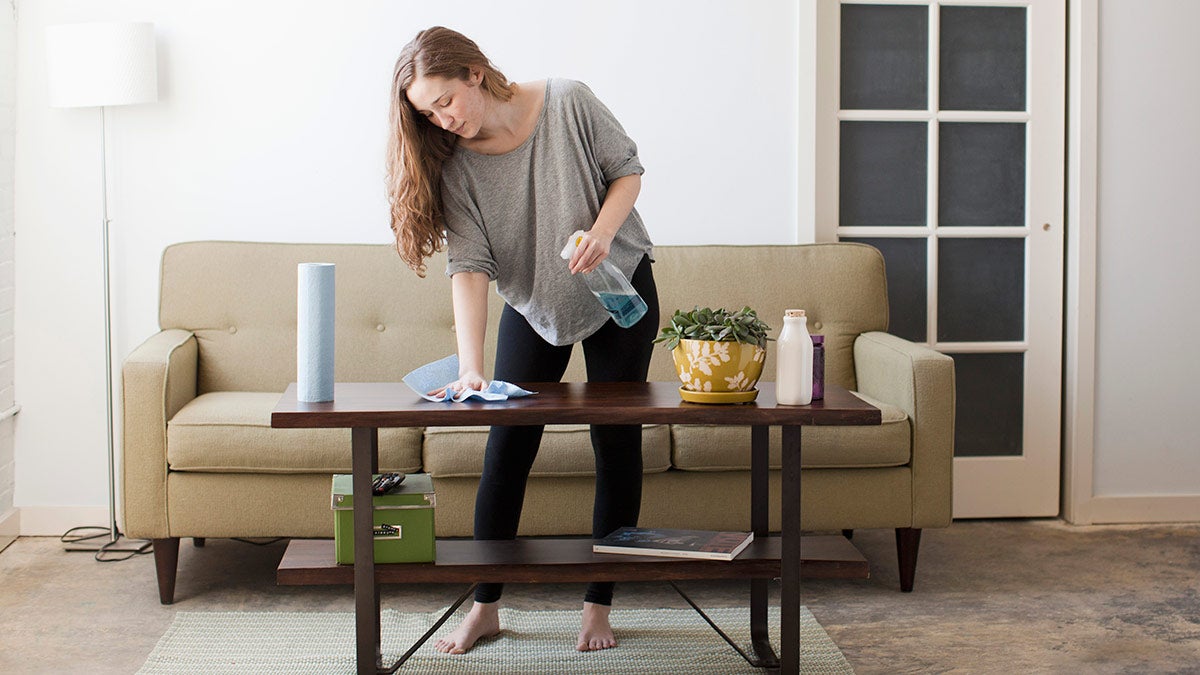 Woman cleaning a coffee table