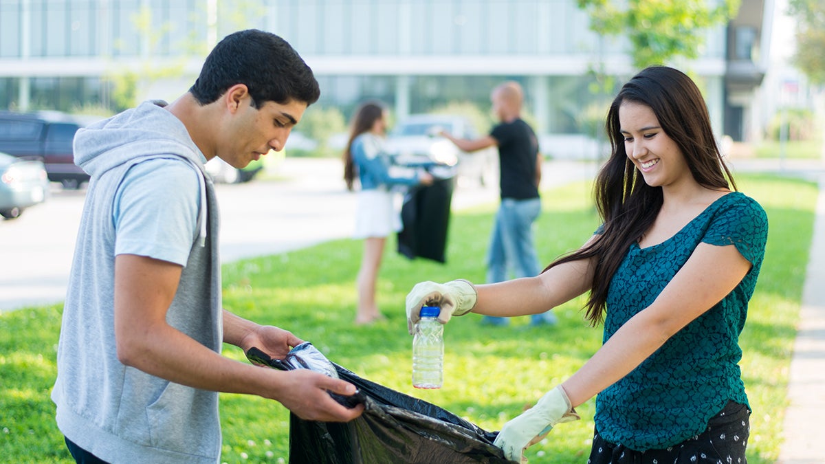 Students picking up litter and recycling plastic water bottles 