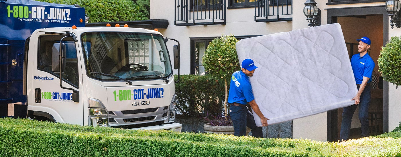 Truck Team Members carrying a mattress 
