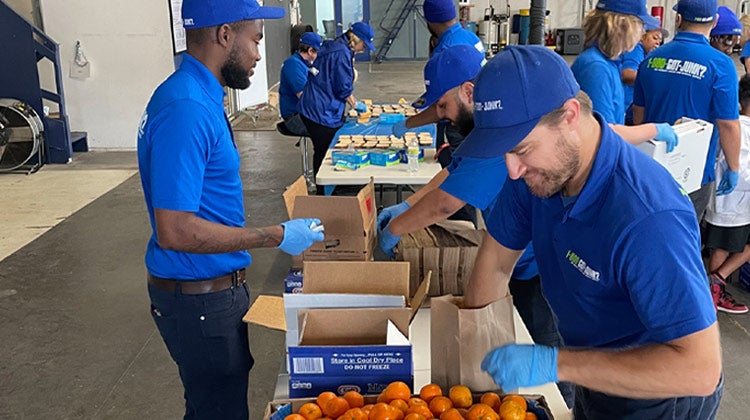 1-800-GOT-JUNK? team members packing meals for charity 1-800-GOT-JUNK? team members packing meals for charity