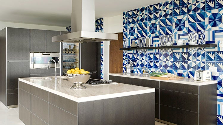 Clean kitchen with a blue patterned tile backsplash 
