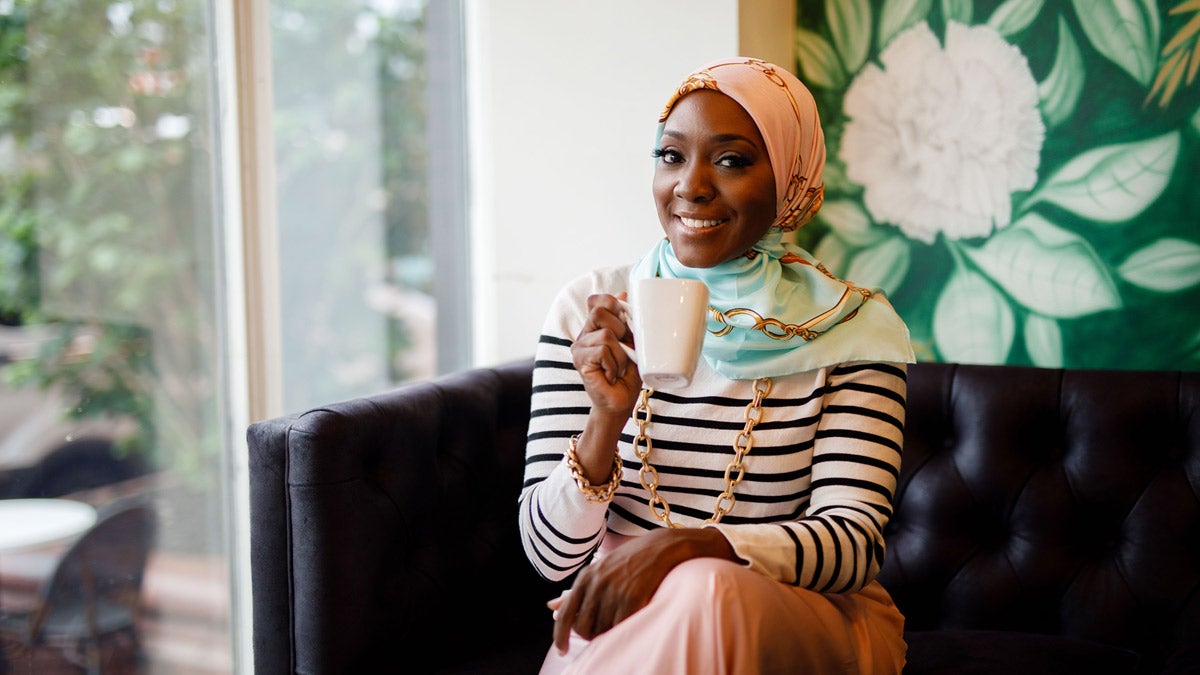 Saudah Saleem sitting on a couch 