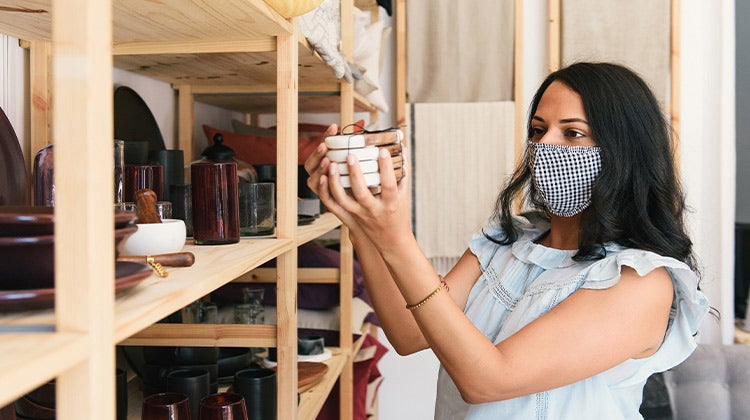 Woman in a mask shopping at a local store