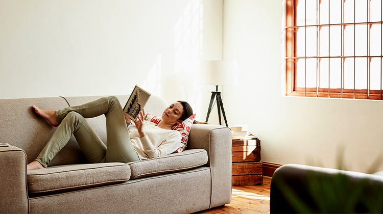 Woman reading on a couch Woman reading on a couch
