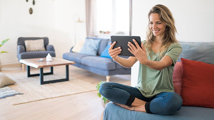 Woman using a tablet to video chat Woman using a tablet to video chat