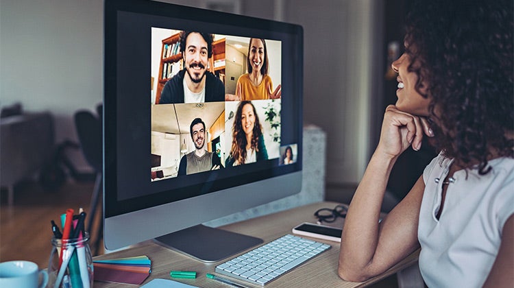 Woman on her computer attending a video event 