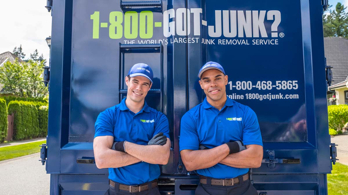 1800-GOT-JUNK? truck team TOM's standing in front of their truck