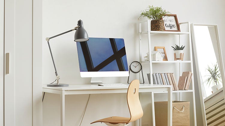 Organized home office with a computer and shelving 