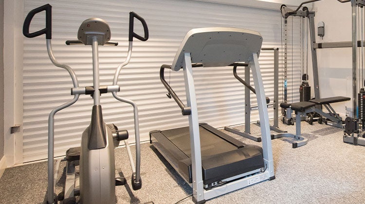 How to get rid of a treadmill Old treadmill surrounded by outdated exercise equipment in gym