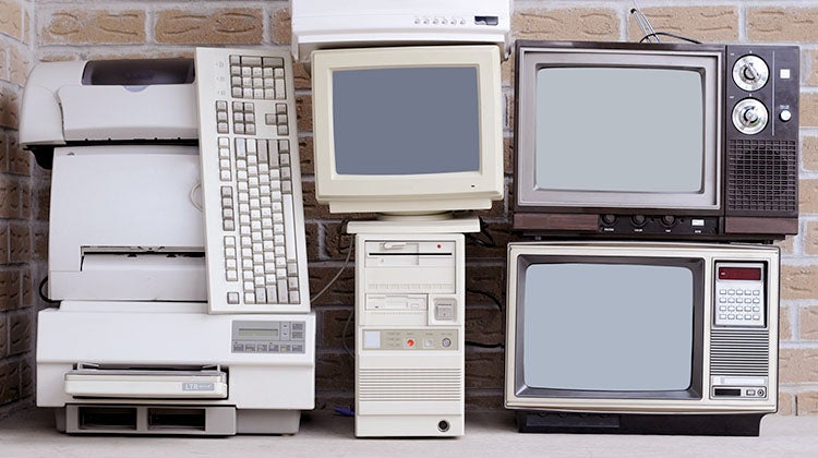 How to dispose of old electronics Stacked pile of outdated electronics
