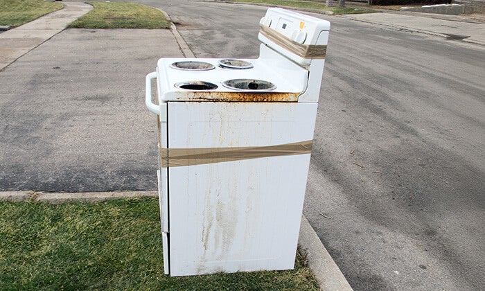 What to do with old stove 1-800-GOT-JUNK? hauls away an old stove with an appliance dolly.