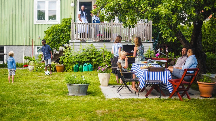 Family and friends enjoying an outdoor barbeque Family and friends enjoying an outdoor barbeque