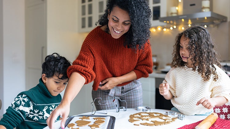 Family baking holiday cookies in a clean kitchen