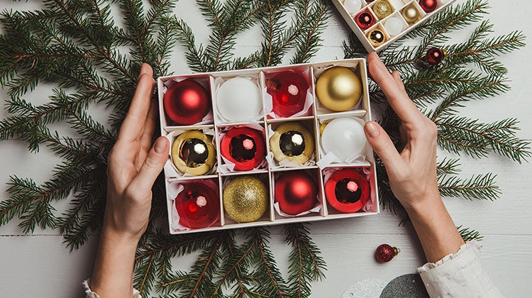 Red, white, and gold holiday ornaments in a box