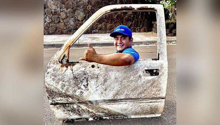 1-800-GOT-JUNK? truck team member pretending to drive with only a car door