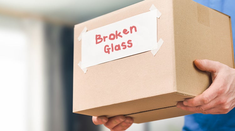 A box containing broken glass pieces taken away by a junk removal team