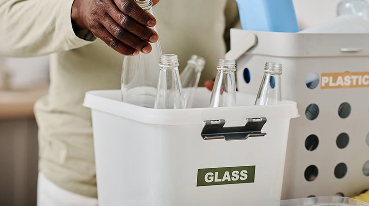 A box with broken glass bottles ready to be disposed off