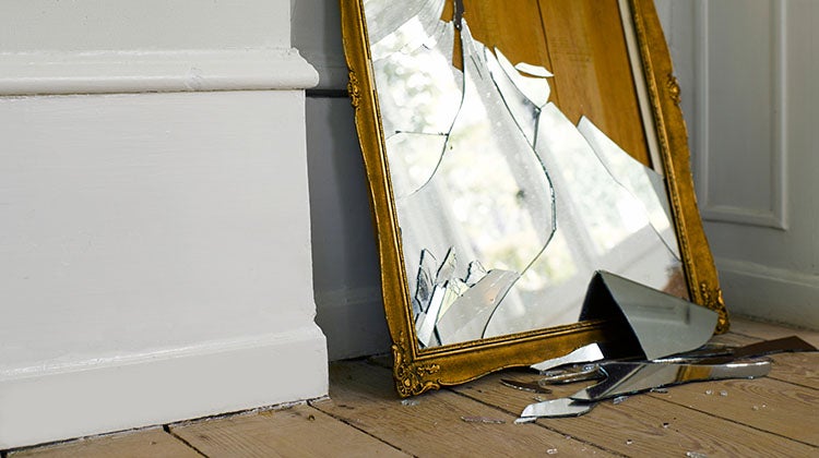 A broken glass mirror ready to be disposed of
