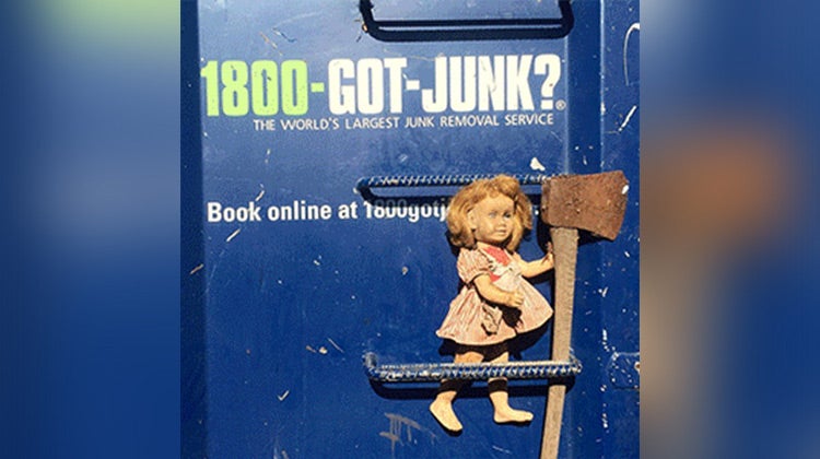 Old doll holding an axe Old doll holding an axe