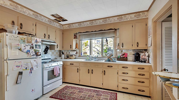 kitchen with beige cupboards and white appliances