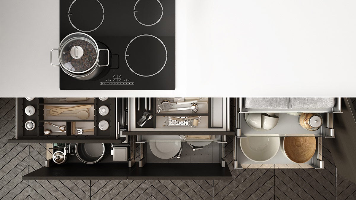 Birds-eye view of a stove top and the open drawers below